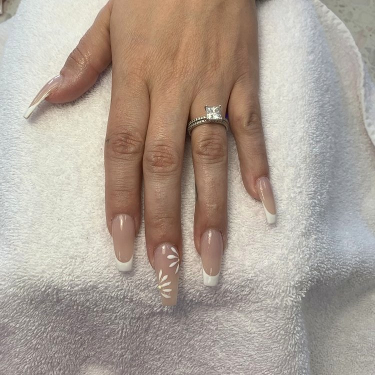 Nude coffin nails with a white French tip and petal accent